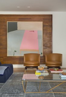  Bright white walls and warm wood details provide the perfect backdrop for an array of colorful furnishings. 