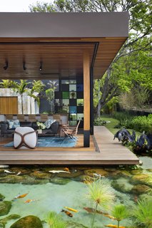 The home appears to float above the natural pool, adding an element of whimsy.