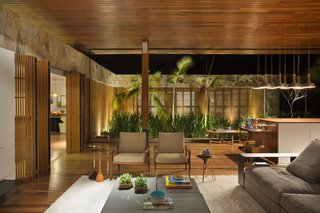 Slatted wood folding doors divide the public and private areas to create visual separation without compromising the home’s inherent openness.