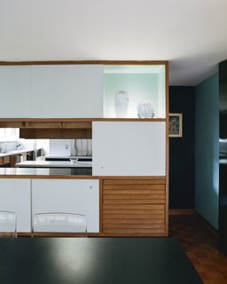  In the dining room, the sliding-panel cedar cabinets feature a glass display case reminiscent <br>of the tokonoma found in traditional Japanese architecture, to which Girard professed a "profound debt." In the kitchen, original pale orange Formica counters were replaced with crisp white ones. 