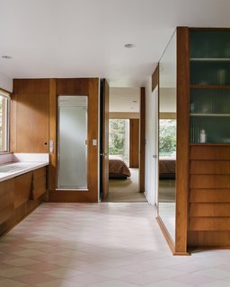 In the master bathroom and dressing room, pink-and-white floor tiles were found hidden under ’70s shag carpeting. 
