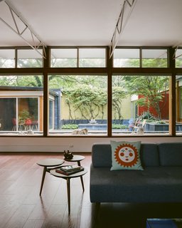 The sofa and side table are from West Elm. The pillow is adorned with a stylized sun that Girard created for the New York restaurant La Fonda del Sol. 