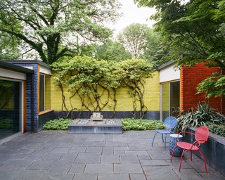 Vines spill over primary-colored, glazed-brick walls, which recall Girard’s eye-popping graphics.