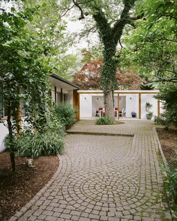 New stone walkways, laid in a swirling pattern, surround the 4,600-square-foot house.