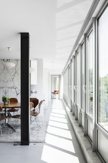The drafty windows on the south facade all had to go. "That alone cost more than my previous house," says Simon. "The heritage people wanted the glass to have the same shine and coloration." 