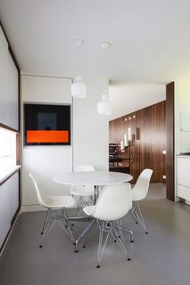 A refurbished Wenge wood cabinet in the kitchen is coated in reflective gloss and an orange strip of MDF; all of the pendants are either original or made-to-measure replicas of Engels’s designs. 