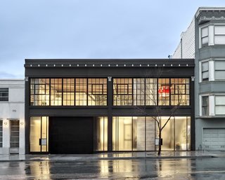 The steel-sash windows by Hope’s on the upper level are replicas of the originals, while the lower level has custom frosted-glass panels. The facade paint is Black Tar by Benjamin Moore.