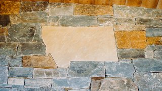 A Montana-shaped stone is just one of the textural details that ground the home in the rugged environment.