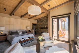 The master bedroom is a texturally rich space and offers views of Lone Peak.