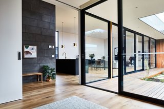 The floor-to-ceiling windows visually connect the entire house.