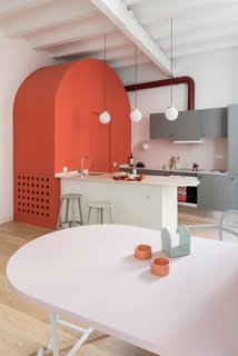 Revolver stools by HAY complement the home's colorful interior.