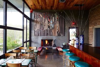 The modern, Mexican-inspired interiors of Capri reflect its menu, with traditional rugs and warm wooden chairs contrasting with carefully selected modern artwork and a sleek bar. 