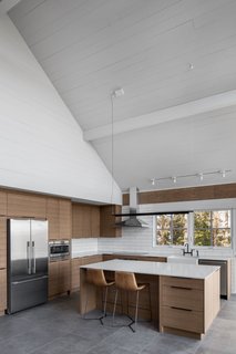 The bar stools are by West Elm. The Compendium suspension light is by Lucepan.