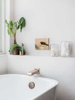 The tub has a tap by Delta Faucet.