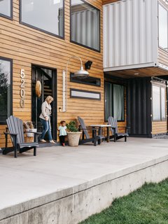 A concrete patio wraps around the house.