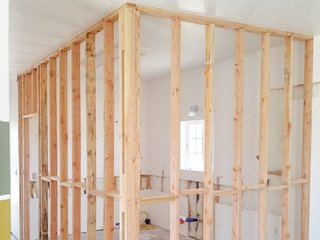 Framing for the new bedroom takes the place of the old kitchen.