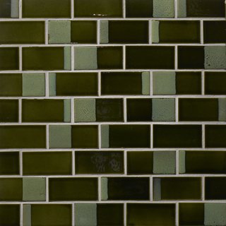 Dual glaze tiles have varying proportions of matte and gloss finishes on each tile, creating unpredictable rhythms when they're installed. Each glazer places a stencil on the tile before spraying it with glaze to create the mesmerizing effect.