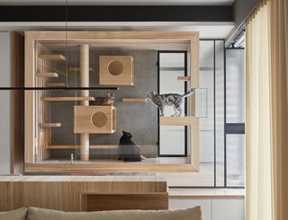 Indot, an interior design firm in Taiwan, designed this suspended enclosure for a client's four cats. The wood frame and interior elements of the cat house mesh with the rest of the home's interior finishes, while the glass ensures the installation doesn't convey too much visual weight.