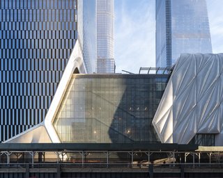 The 4,000-ton outer shell of the Shed glides along rails to retract telescopically on six-foot-tall wheels.