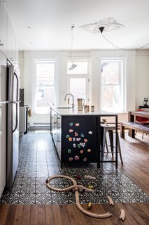 The first floor of this house, built in1885 and located in the McGill neighborhood of Montreal, was the perfect spot for a large kitchen and living area, which was missing from the old layout—a makeshift kitchen was previously located on the floor above. The clients, a web developer and a jewelry designer with a son, wanted a centralized space for eating and entertaining. The kitchen island contains three cabinets from IKEA, retrofitted with custom doors, as well as a dishwasher.