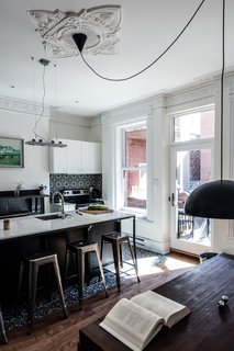 The pendant that covers the picnic-style dining table is an IKEA model, modified with a longer electrical cord.