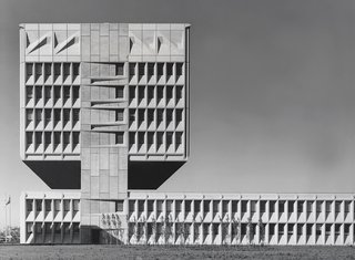 The Armstrong Rubber Company headquarters in New Haven, Connecticut, features a two-story gap between a lower-level laboratory building and an office tower. Since the building is situated next to the Connecticut Turnpike, the gap was meant to precisely align with passing drivers' eye level. (1965-1970)
