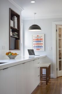 Fein also renovated the kitchen in a 1930s bungalow in Kansas City, Missouri. The countertop of a custom cabinet creates a breakfast nook at one end.