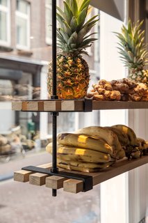 Suspended shelves made of wood planks display organic ingredients. Photo by Wouter van der Sar.