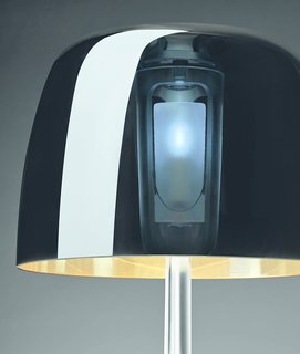 The 25th anniversary version of Lumiere features a metallic glass shade that still lets light pass through; four layers (paliesco, crystal, white, and metallic coating) make up the piece.