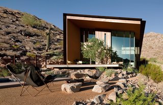 One of our featured homes is the Jarson Residence, designed by Will Bruder of Will Bruder Architects and characterized by a simple shed roof with deep overhangs. The exterior of the sculptural structure is covered with rusted steel and copper that blends well with the surrounding rocky topogrpahy. 