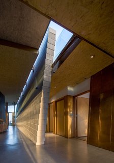 The Bryne Residence is made up of tilted masonry "canyon walls" and a combination of naturally patinated copper and acid etched galvanized metal. Because of the implementation of these materials, the color of the house changes with the shifting sunlight.