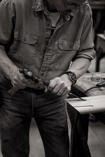 Taken at the workshop in Lancaster County, this image shows how each piece is carefully produced from start to finish. One of the Smilow craftsmen is shown here making precise notches into a piece of American walnut.