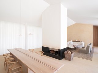 Nestled in the private residential estate of Les Parcs de Saint Tropez, this contemporary home was created by the London-based minimalist designer, John Pawson. Clean lines and bright white walls frame the freestanding fireplace, making for a dynamic open living space where the fireplace acts as the heart of the room.