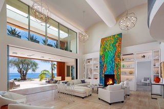 Located in the Hope Ranch neighborhood of Santa Barbara, California, this striking home sits on an almost four-acre bluff with over 200 feet of ocean contact. The art-adorned fireplace acts as the centerpiece of the living room that opens up to unobstructed views of the Pacific Ocean. 