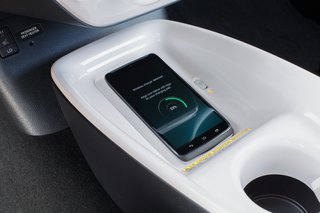 Hitting the Road With the Newest Hybrid Technologies - Photo 4 of 8 - With the Qi-compatible wireless smartphone charging system*, you can charge your phone by placing a compatible device onto the nonslip surface. *The Qi wireless charging may not be compatible with all mobile phones, MP3/WMA players, and like models. When using the wireless charging system, avoid placing metal objects between the wireless charger and the mobile device when charging is active. Doing so may cause metal objects to become hot and could cause burns. To prevent damage to devices, do not leave the devices in the vehicle. Temperature inside may become high, resulting in damage to the device.