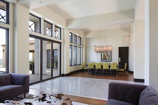 Upon entering from the front, you’re greeted by an open layout designed by Zampino with a living space on one side and the dining space on the other. The sets of windows framing each of these spaces were ordered custom through Marvin. Garcia worked with a local representative who helped him with his special orders each step of the way. 