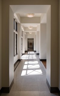 Garcia placed Marvin windows all along an extensive corridor. The windows let natural light pour in while allowing the x-shaped wood beams from the exterior overhangs to reflect their shadows along the limestone flooring. 