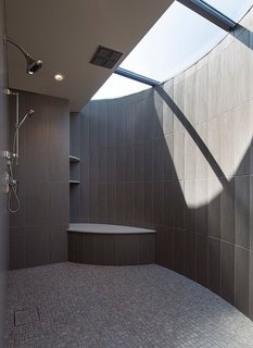 For the master bathroom, he worked with a fabricator to design a custom crescent-shaped skylight that lets light stream into the shower. 
