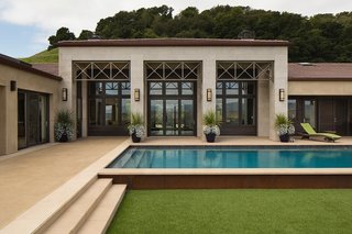 Francis designed the pool to be as close to the house as possible so that it’s protected from the wind that whips through from the other side of the house. It’s easily accessible from the interior through a selection of sliding glass doors from Marvin. 