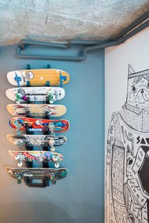 A custom board rack provides a space for the kids of the house to show off their prized decks. 