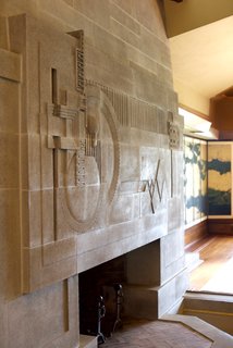 One of the standout moments in the space is the cast-concrete fireplace, which is considered to be one of Wright’s greatest two-dimensional works of art. He completed the fireplace, a skylight above, and a moat that was designed to hold a pool of water. This was originally part of an elaborate water scheme to run through the property, though it was never completed. 