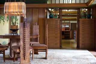 Many of the elements throughout were influenced by his Prairie houses, including built-in furnishings, a substantial amount of wood, and art glass. The dining set was created custom by Wright and features a low seat and straight back—both signs of the Prairie style—and also boasts the Hollyhock motif running up the spine of the chair and the table’s pedestal.