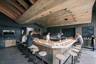 At KazuNori’s new second location, Marmol Radziner built the U-shaped bar out of bleached eucalyptus wood, while the walls are made of plaster and board-and-batten wood. The sculptural dropped ceiling is constructed of bleached rustic white oak and lined with a warm lighting scheme. 