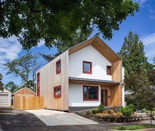 Dwell Home Tours Makes its Way to Portland - Photo 1 of 17 - The exterior of the Phoenix Passive House is lined with locally milled cedar siding. With a dual-wall construction, the structure is covered with an Agepan weather protective barrier—also known as wax-impregnated fiberboard. The triple-paned windows were fabricated in Seattle and framed with Oregon-grown FSC certified wood. They’re outfitted with automated exterior solar shades. Additionally, the house is prewired for a car charging station. 