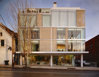Dwell Home Tours Makes its Way to Portland - Photo 4 of 17 - From the street view of the Glisan Street Residence, you can see the mix of materials that make up the structure including a steel frame, large expanses of windows, stainless steel mesh panels, and slate cladding. The ground floor hosts a storefront with floor-to-ceiling windows from one exposure. 