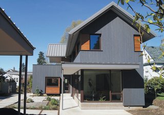 Dwell Home Tours Makes its Way to Portland - Photo 10 of 17 - Interspersed throughout the gray siding are segments of horizontal natural finished cedar siding that they installed themselves. To fit with their active indoor/outdoor lifestyle, they included an exterior bike room that’s accessible under the house’s cover. 