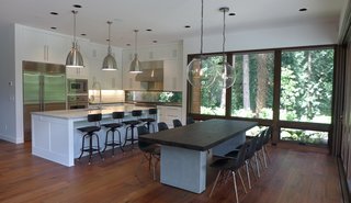 Dwell Home Tours Makes its Way to Portland - Photo 16 of 17 - Olson worked with Jessie Sweet to design the interiors. The kitchen hosts cabinetry from Oregon Custom Cabinets and a specialized window is integrated into the backsplash. 