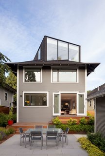 Dwell Home Tours Makes its Way to Portland - Photo 7 of 17 - Thomas Robinson of LEVER Architecture restored the exterior of the house in order to resurface the original wood facade, which had been covered up by vinyl siding at one point. They turned the unused attic into a "FifthSquare": a box-like structure that acts as an office and mini-theater, complete with a ceiling-mounted projector and drop-down screen. The exterior of the extension is clad with charred cedar, which integrates smoothly into the asphalt shingle roof. 