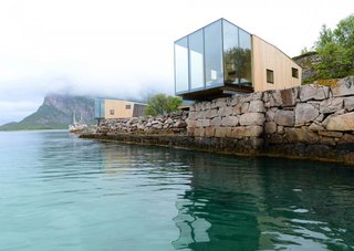 This boutique hotel on Norway's Manshausen Island is made up of four sea cabins that jut out from their natural ledge. Architect Snorre Stinessen carefully positioned them on an existing stone quay and built them to fit two to four travelers, or a family of five. To allow them to cantilever off the edge, their cross-laminated timber floor plates are mounted onto two steel beams.