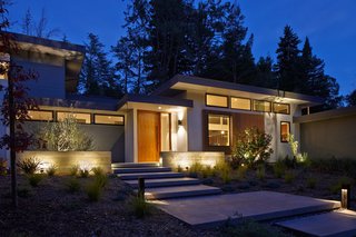 Dwell Home Tours Lands in Silicon Valley - Photo 13 of 15 - The exterior of the Erica Residence is made up of smooth plaster, painted wood siding, stained cedar accent features, and board-formed concrete site walls. 